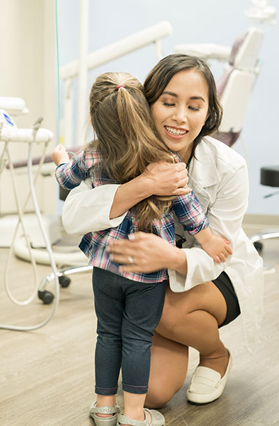 Dr. Tran with a child at TLC Pediatric Dentistry